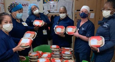 Health Care workers holding donated meals 